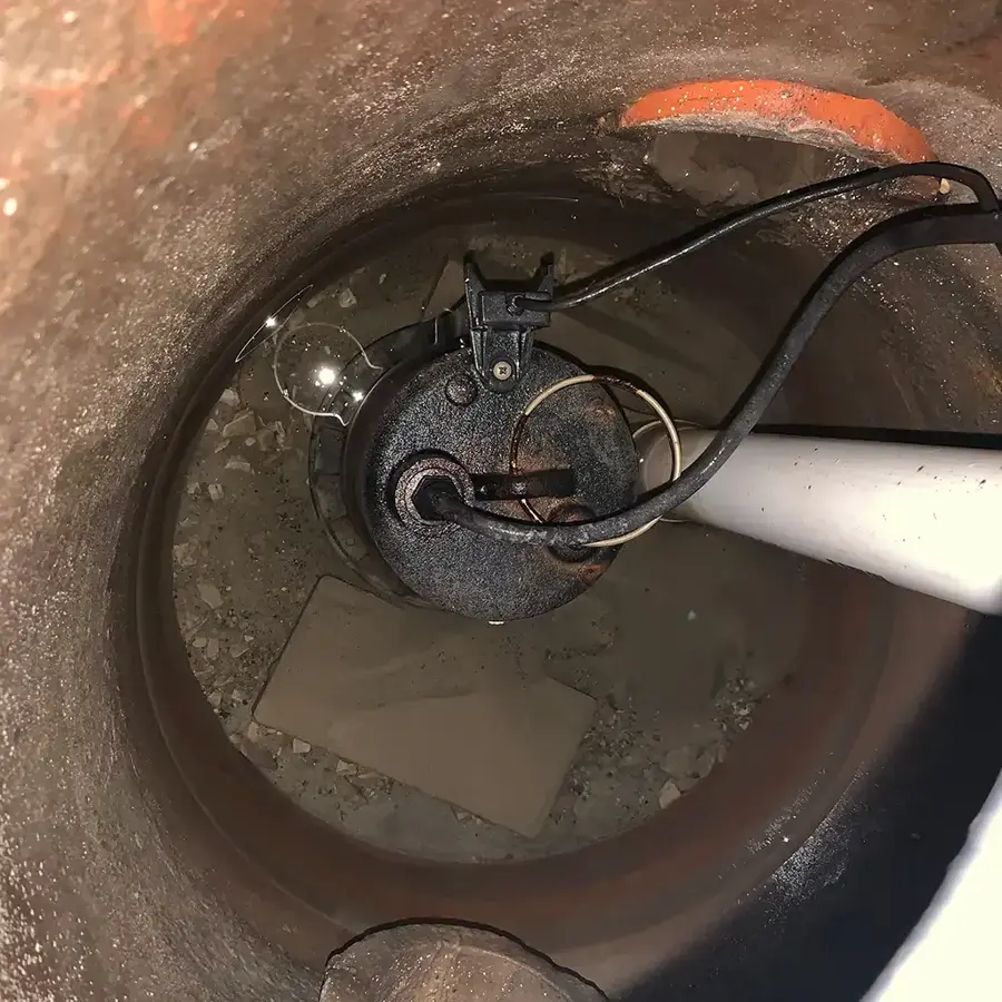 Submersible sump pump sitting in a basement sump pit in Rochester, MI