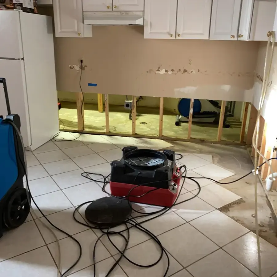 Air mover and dehumidifier drying a kitchen after flood cuts in Rochester, MI