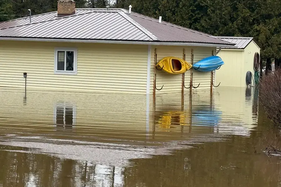 River floodwater around a house during spring high water in Oakland County, MI