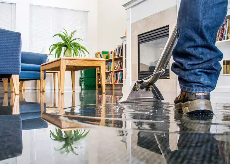 Extraction wand pulling standing water off a flooded floor in a Rochester, MI home