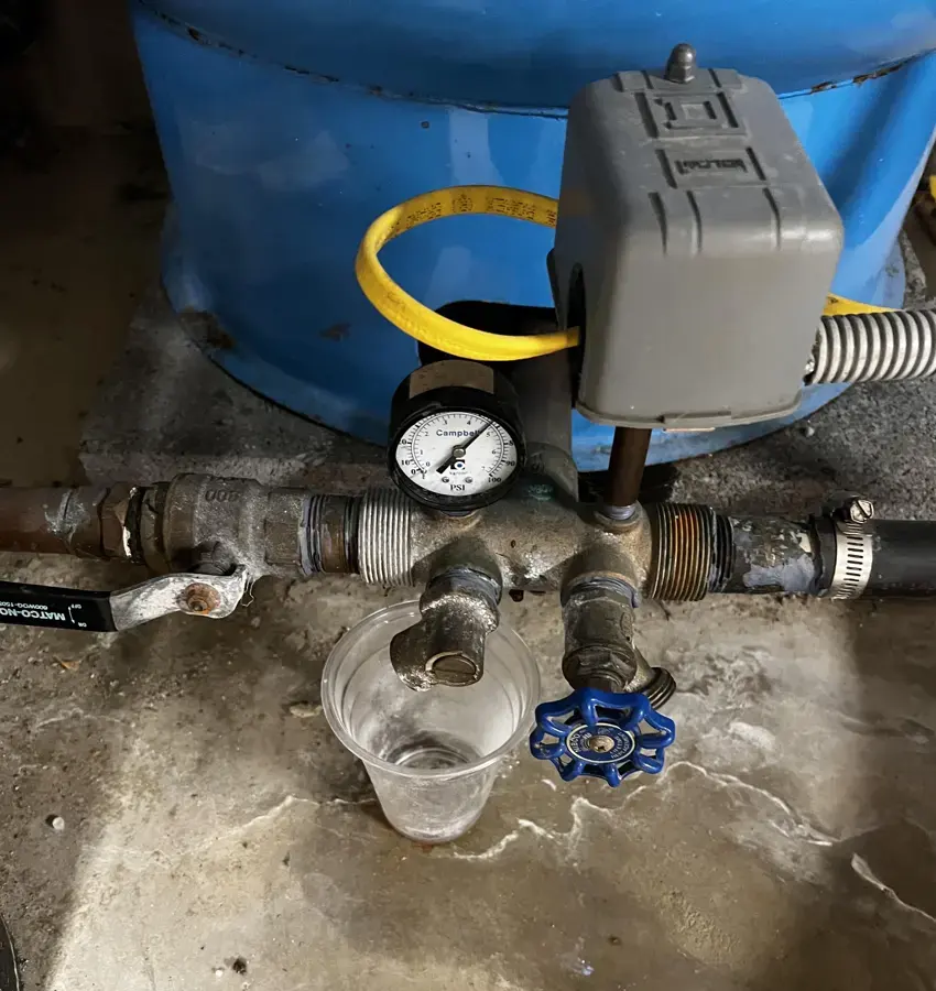 Well pressure tank fittings leaking onto a basement floor near Rochester, MI